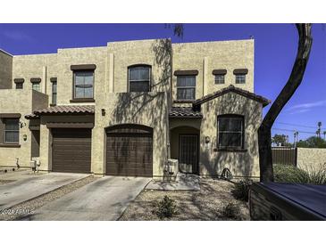 Two-story stucco home with a double-car garage and desert landscaping at 1943 E Hayden Ln # 103, Tempe, AZ 85281