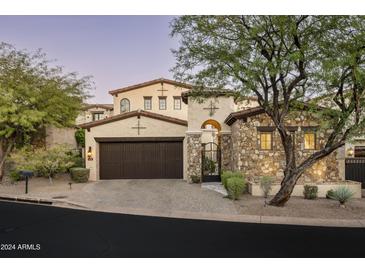 Stunning two-story home with stone accents and a three-car garage at 19501 N 101St St, Scottsdale, AZ 85255