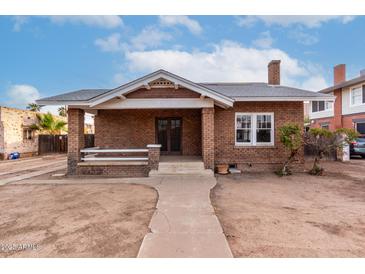 Brick house with a front porch and a spacious yard at 71 E Hoover Ave, Phoenix, AZ 85004