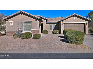Single-story home with landscaped front yard and two-car garage at 7132 W Trenton Way, Florence, AZ 85132