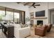 Bright living room featuring a fireplace, comfortable seating, and large windows at 3119 S Prospector Cir, Gold Canyon, AZ 85118