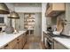 Modern kitchen with light green cabinets, large island, and high-end appliances at 3119 S Prospector Cir, Gold Canyon, AZ 85118