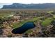 Aerial view of a luxury community with a golf course and mountain views at 3149 S Prospector Cir, Gold Canyon, AZ 85118