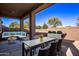 Covered patio with seating area and dining table at 10746 E Dragoon Cir, Mesa, AZ 85208