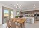 Modern kitchen with island, stainless steel appliances, and dining area at 10746 E Dragoon Cir, Mesa, AZ 85208