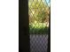View of putting green through a diamond-patterned glass door at 10100 N 78Th Pl, Scottsdale, AZ 85258