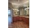 Double vanity bathroom with granite countertops and wood floors at 10100 N 78Th Pl, Scottsdale, AZ 85258