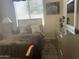 Bright bedroom with a queen-size bed, dresser and window coverings at 10100 N 78Th Pl, Scottsdale, AZ 85258