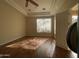 Sunlit bedroom with hardwood floors and an open door at 10100 N 78Th Pl, Scottsdale, AZ 85258
