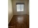 Bright bedroom featuring wood-look flooring and window at 10100 N 78Th Pl, Scottsdale, AZ 85258