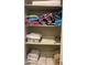 Linen closet with shelves, neatly organized with towels, bedding, and other linens at 10100 N 78Th Pl, Scottsdale, AZ 85258