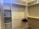 Walk-in closet with shelves, a hanging rod, and storage bins at 10100 N 78Th Pl, Scottsdale, AZ 85258