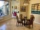 Dining area with a glass-top table, four chairs, and views of the backyard at 10100 N 78Th Pl, Scottsdale, AZ 85258