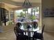 Breakfast nook with a glass-top table and chairs, overlooking a beautiful backyard and pool at 10100 N 78Th Pl, Scottsdale, AZ 85258
