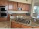 Island kitchen with granite countertops and gas cooktop at 10100 N 78Th Pl, Scottsdale, AZ 85258