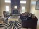 Spacious living room with stone fireplace and comfortable seating at 10100 N 78Th Pl, Scottsdale, AZ 85258