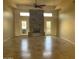 Large living room with a stone fireplace and tile flooring at 10100 N 78Th Pl, Scottsdale, AZ 85258