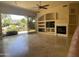 Spacious living room with fireplace, built-ins, and backyard access at 10100 N 78Th Pl, Scottsdale, AZ 85258