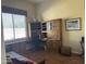 Home office featuring built-in wooden desk and window with blinds at 10100 N 78Th Pl, Scottsdale, AZ 85258