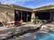 Large patio with seating area, adjacent to pool and landscaping at 10100 N 78Th Pl, Scottsdale, AZ 85258