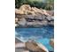 Stunning pool with large rocks and lush landscaping at 10100 N 78Th Pl, Scottsdale, AZ 85258