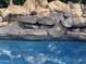 Relaxing pool area with a natural rock waterfall feature at 10100 N 78Th Pl, Scottsdale, AZ 85258