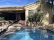 Spacious patio, pool with a waterfall, and comfortable seating at 10100 N 78Th Pl, Scottsdale, AZ 85258