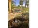 Peaceful backyard with a sparkling pool, stone patio, and palm trees at 10100 N 78Th Pl, Scottsdale, AZ 85258