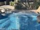 Inviting swimming pool with a stone patio and tropical landscaping at 10100 N 78Th Pl, Scottsdale, AZ 85258