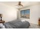 Comfortable bedroom with a queen bed, ceiling fan and a view from the window at 7233 W Corrine Dr, Peoria, AZ 85381