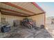 Covered shelter with a riding vehicle and hay bales at 29202 N 146Th St, Scottsdale, AZ 85262