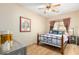 Bedroom with a queen bed, ceiling fan, and wood flooring at 29202 N 146Th St, Scottsdale, AZ 85262