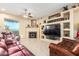 Spacious living room with a fireplace and built-in entertainment center at 29202 N 146Th St, Scottsdale, AZ 85262