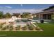 Expansive backyard with a large pool, spa, and grassy area at 8366 E Old Paint Trl, Scottsdale, AZ 85266