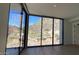 Bright bedroom with large windows and mountain views at 4849 N Camelback Ridge Rd # B201, Scottsdale, AZ 85251