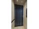Modern elevator with sleek black mesh doors at 37200 N Cave Creek Rd # 2120, Scottsdale, AZ 85262