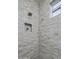 Shower with tile surround and built-in shelving at 37200 N Cave Creek Rd # 2120, Scottsdale, AZ 85262