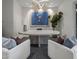 Modern home office features an oval desk and stylish light fixture at 37200 N Cave Creek Rd # 2120, Scottsdale, AZ 85262