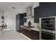 Modern kitchen with stainless steel appliances and dark cabinetry at 37200 N Cave Creek Rd # 2120, Scottsdale, AZ 85262