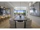 Open concept dining room with a long table and access to patio at 37200 N Cave Creek Rd # 2120, Scottsdale, AZ 85262