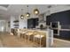 Modern kitchen with dark cabinetry, island seating, and high-end appliances at 37200 N Cave Creek Rd # 2120, Scottsdale, AZ 85262