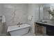 Bathroom with a freestanding soaking tub and marble wall at 37200 N Cave Creek Rd # 2120, Scottsdale, AZ 85262