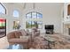 Bright living room with large windows, a fireplace, and comfortable seating for relaxation at 18448 E Paseo Verde Dr, Rio Verde, AZ 85263