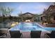 Luxury backyard oasis featuring a rectangular pool, covered patio, and fire pit at 8510 E Tecolote Cir, Scottsdale, AZ 85266