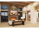 Spacious living room with a large stone fireplace and high wood beam ceilings at 8510 E Tecolote Cir, Scottsdale, AZ 85266