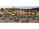 Beautiful home exterior with a three car garage and desert landscaping at 8510 E Tecolote Cir, Scottsdale, AZ 85266