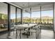Dining area with mountain views and modern lighting through large windows at 37200 N Cave Creek Rd # 1009, Scottsdale, AZ 85262