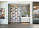 Modern wine room with glass enclosure, temperature-controlled storage, and accent lighting at 37200 N Cave Creek Rd # 1009, Scottsdale, AZ 85262