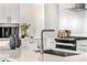 Modern kitchen island with sink, faucet, and quartz countertop at 3131 N Central Ave # 4015, Phoenix, AZ 85012