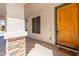 Inviting front porch with stone columns and wood door at 1327 E Judi Dr, Casa Grande, AZ 85122